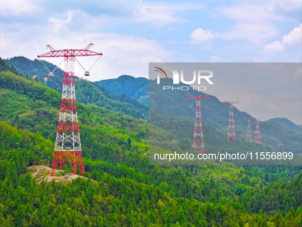 The iron tower of the 800 kV UHVDC power transmission project is built in Jinshang-Hubei Province, Chongqing, China, on September 7, 2024. T...