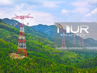 The iron tower of the 800 kV UHVDC power transmission project is built in Jinshang-Hubei Province, Chongqing, China, on September 7, 2024. T...