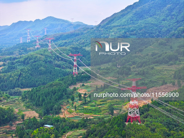 The iron tower of the 800 kV UHVDC power transmission project is built in Jinshang-Hubei Province, Chongqing, China, on September 7, 2024. T...