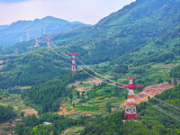 The iron tower of the 800 kV UHVDC power transmission project is built in Jinshang-Hubei Province, Chongqing, China, on September 7, 2024. T...