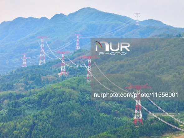 The iron tower of the 800 kV UHVDC power transmission project is built in Jinshang-Hubei Province, Chongqing, China, on September 7, 2024. T...