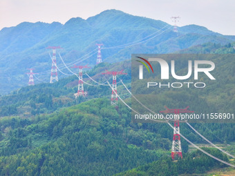 The iron tower of the 800 kV UHVDC power transmission project is built in Jinshang-Hubei Province, Chongqing, China, on September 7, 2024. T...