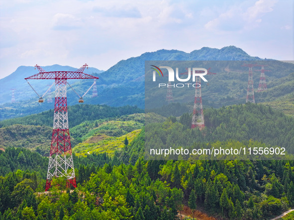 The iron tower of the 800 kV UHVDC power transmission project is built in Jinshang-Hubei Province, Chongqing, China, on September 7, 2024. T...