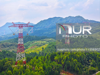 The iron tower of the 800 kV UHVDC power transmission project is built in Jinshang-Hubei Province, Chongqing, China, on September 7, 2024. T...