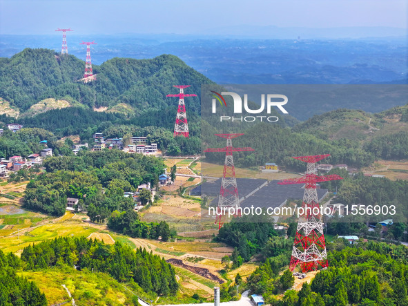 The iron tower of the 800 kV UHVDC power transmission project is built in Jinshang-Hubei Province, Chongqing, China, on September 7, 2024. T...