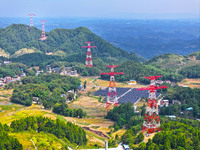 The iron tower of the 800 kV UHVDC power transmission project is built in Jinshang-Hubei Province, Chongqing, China, on September 7, 2024. T...