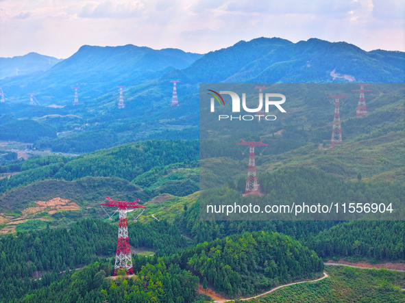 The iron tower of the 800 kV UHVDC power transmission project is built in Jinshang-Hubei Province, Chongqing, China, on September 7, 2024. T...