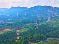 The iron tower of the 800 kV UHVDC power transmission project is built in Jinshang-Hubei Province, Chongqing, China, on September 7, 2024. T...