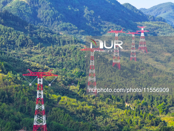 The iron tower of the 800 kV UHVDC power transmission project is built in Jinshang-Hubei Province, Chongqing, China, on September 7, 2024. T...