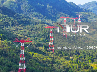 The iron tower of the 800 kV UHVDC power transmission project is built in Jinshang-Hubei Province, Chongqing, China, on September 7, 2024. T...