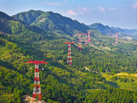 The iron tower of the 800 kV UHVDC power transmission project is built in Jinshang-Hubei Province, Chongqing, China, on September 7, 2024. T...