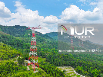 The iron tower of the 800 kV UHVDC power transmission project is built in Jinshang-Hubei Province, Chongqing, China, on September 7, 2024. T...