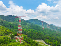 The iron tower of the 800 kV UHVDC power transmission project is built in Jinshang-Hubei Province, Chongqing, China, on September 7, 2024. T...