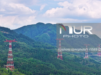 The iron tower of the 800 kV UHVDC power transmission project is built in Jinshang-Hubei Province, Chongqing, China, on September 7, 2024. T...