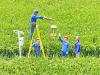 Workers inspect intelligent agricultural monitoring equipment and guide farmers to use it in Chuzhou, China, on September 7, 2024. (