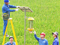 Workers inspect intelligent agricultural monitoring equipment and guide farmers to use it in Chuzhou, China, on September 7, 2024. (