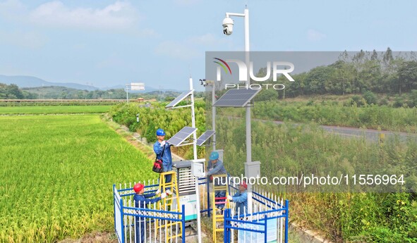 Workers carry out an overhaul of intelligent agricultural monitoring equipment in Chuzhou, China, on September 7, 2024. 