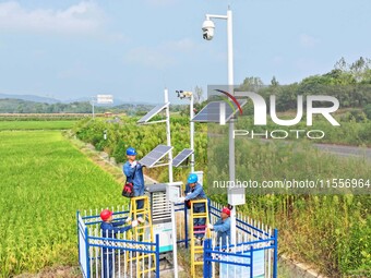 Workers carry out an overhaul of intelligent agricultural monitoring equipment in Chuzhou, China, on September 7, 2024. (