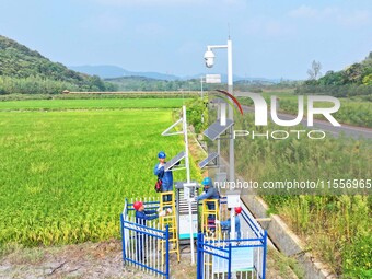 Workers carry out an overhaul of intelligent agricultural monitoring equipment in Chuzhou, China, on September 7, 2024. (