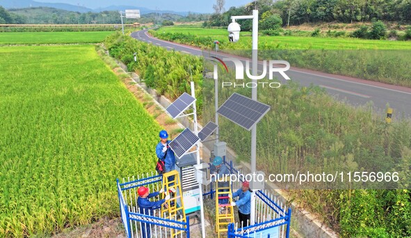 Workers carry out an overhaul of intelligent agricultural monitoring equipment in Chuzhou, China, on September 7, 2024. 