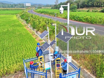 Workers carry out an overhaul of intelligent agricultural monitoring equipment in Chuzhou, China, on September 7, 2024. (