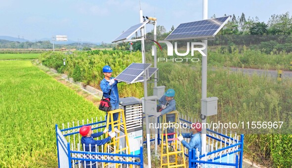 Workers carry out an overhaul of intelligent agricultural monitoring equipment in Chuzhou, China, on September 7, 2024. 