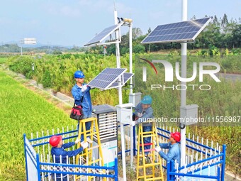 Workers carry out an overhaul of intelligent agricultural monitoring equipment in Chuzhou, China, on September 7, 2024. (