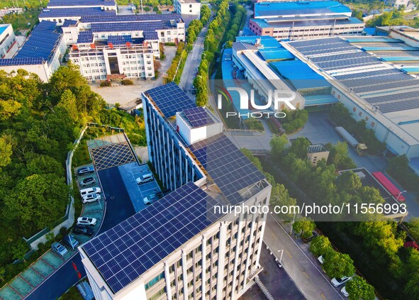 Photovoltaic panels are installed on the roofs of enterprises in Yuexi Economic Development Zone in Anqing, China, on September 8, 2024. 