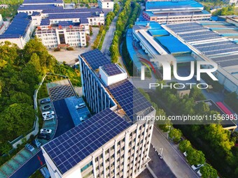 Photovoltaic panels are installed on the roofs of enterprises in Yuexi Economic Development Zone in Anqing, China, on September 8, 2024. (