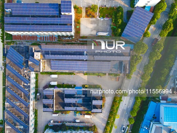 Photovoltaic panels are installed on the roofs of enterprises in Yuexi Economic Development Zone in Anqing, China, on September 8, 2024. 