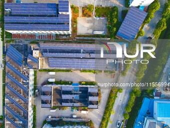 Photovoltaic panels are installed on the roofs of enterprises in Yuexi Economic Development Zone in Anqing, China, on September 8, 2024. (