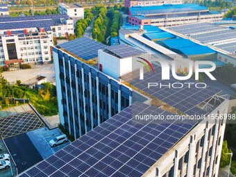 Photovoltaic panels are installed on the roofs of enterprises in Yuexi Economic Development Zone in Anqing, China, on September 8, 2024. (