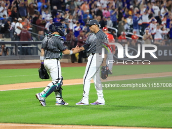 New York Mets catcher Francisco Alvarez #4 and relief pitcher Edwin Diaz #39 celebrate the Mets' 4-0 win in the baseball game against the Ci...