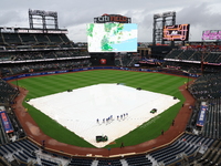 The New York Mets grounds crew prepares the field before the baseball game between the Cincinnati Reds and New York Mets at Citi Field in Co...