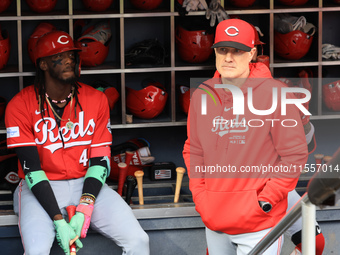 Cincinnati Reds Elly De La Cruz #44 and manager David Bell #25 stand in the dugout before the baseball game against the New York Mets at Cit...