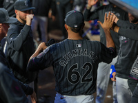 New York Mets starting pitcher Jose Quintana #62 receives congratulations in the dugout after leaving the game during the seventh inning of...