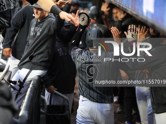 Brandon Nimmo #9 of the New York Mets is congratulated in the dugout after scoring during the sixth inning of the baseball game against the...