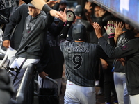 Brandon Nimmo #9 of the New York Mets is congratulated in the dugout after scoring during the sixth inning of the baseball game against the...