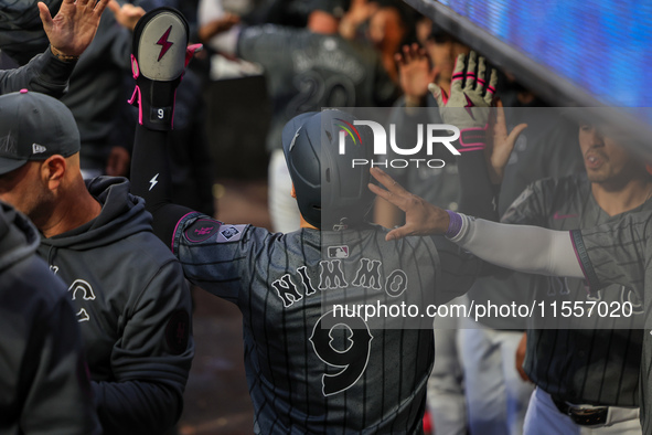 Brandon Nimmo #9 of the New York Mets is congratulated in the dugout after scoring during the sixth inning of the baseball game against the...