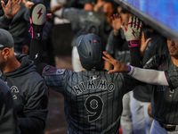 Brandon Nimmo #9 of the New York Mets is congratulated in the dugout after scoring during the sixth inning of the baseball game against the...