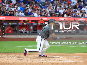 Pete Alonso #20 of the New York Mets singles during the sixth inning of the baseball game against the Cincinnati Reds at Citi Field in Coron...