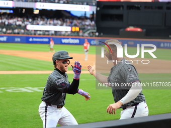 Harrison Bader #44 of the New York Mets celebrates with a teammate after hitting a home run during the sixth inning of the baseball game aga...