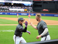 Harrison Bader #44 of the New York Mets celebrates with a teammate after hitting a home run during the sixth inning of the baseball game aga...