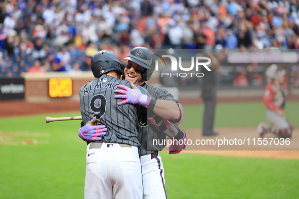 Harrison Bader #44 of the New York Mets celebrates with a teammate after hitting a home run during the sixth inning of the baseball game aga...