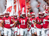 Wisconsin Badgers outside linebacker Darryl Peterson #17 fist bumps outside linebacker Leon Lowery Jr. #8 as the Wisconsin Badgers take the...