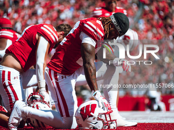 Wisconsin Badgers cornerback Jace Arnold #22 takes a knee before the game at Camp Randall Stadium in Madison, Wisconsin, on September 7, 202...