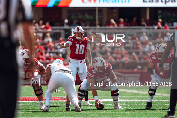 Wisconsin Badgers quarterback Tyler Van Dyke #10 points out the South Dakota Coyotes defense at Camp Randall Stadium in Madison, Wisconsin,...