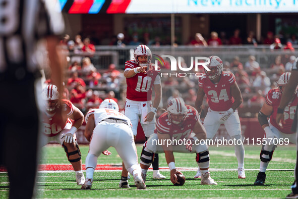 Wisconsin Badgers quarterback Tyler Van Dyke #10 points out the South Dakota Coyotes defense at Camp Randall Stadium in Madison, Wisconsin,...