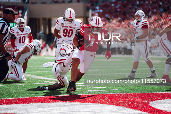 Wisconsin Badgers running back Chez Mellusi #1 scores a touchdown against the South Dakota Coyotes at Camp Randall Stadium in Madison, Wisco...