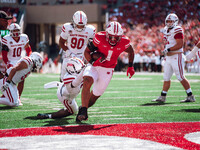 Wisconsin Badgers running back Chez Mellusi #1 scores a touchdown against the South Dakota Coyotes at Camp Randall Stadium in Madison, Wisco...